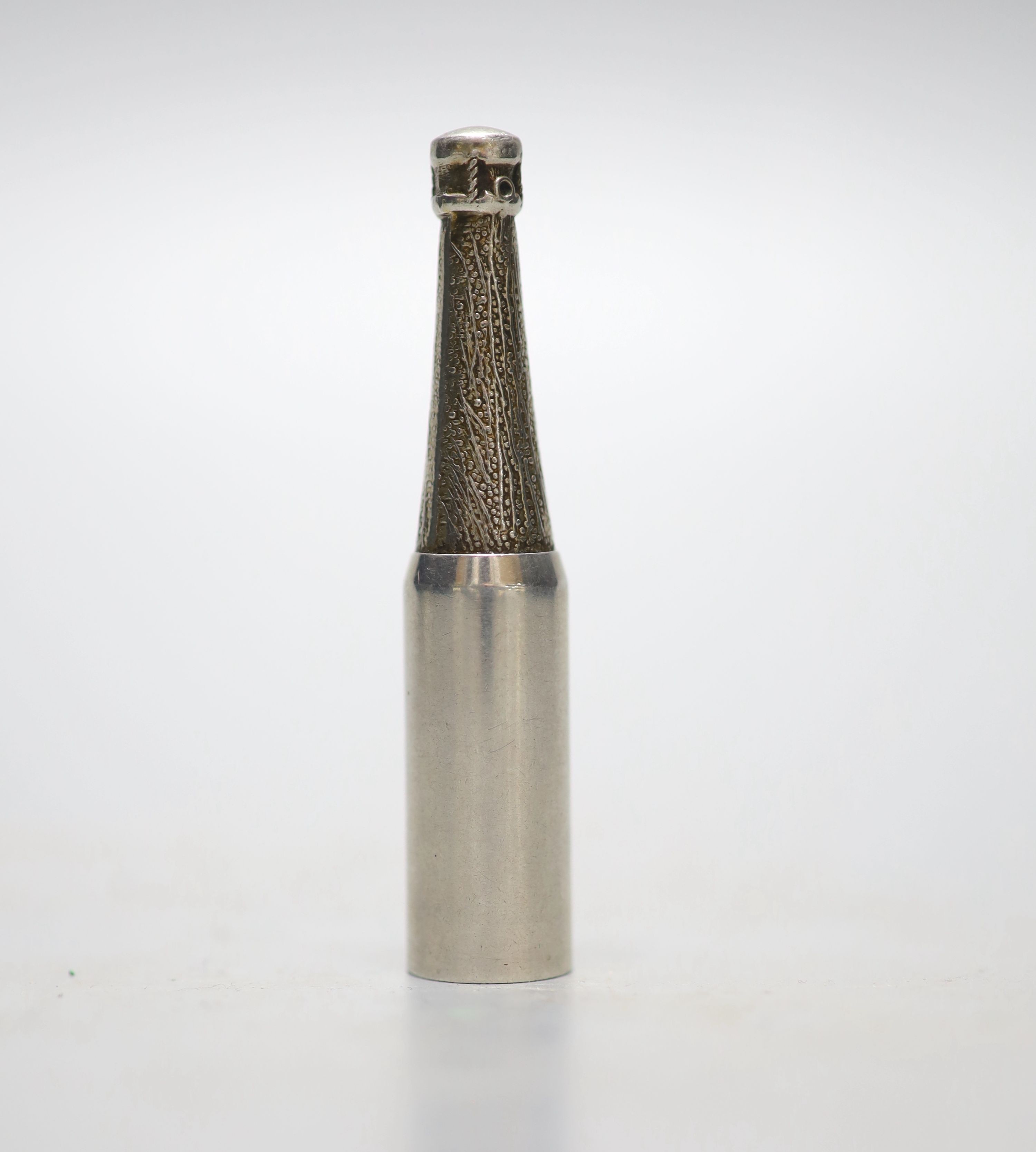 A late 1950's novelty silver cigar piercer, modelled as a champagne bottle, Mappin & Webb, London, 1957, 65mm.